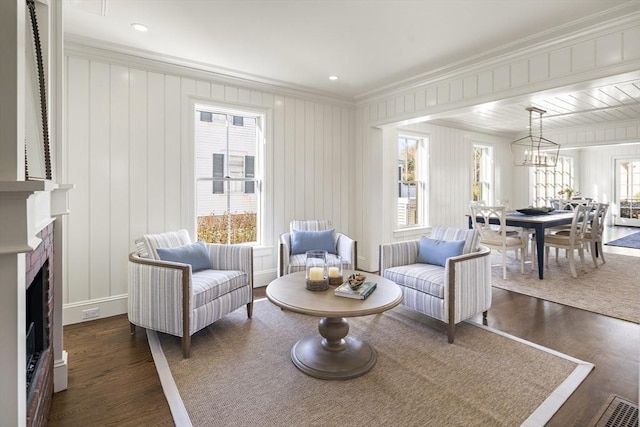 sitting room featuring crown molding and dark hardwood / wood-style floors