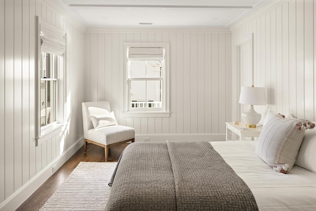 bedroom with multiple windows, dark wood-type flooring, and ornamental molding