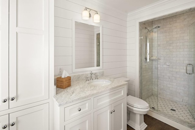 bathroom with wood walls, vanity, wood-type flooring, and an enclosed shower