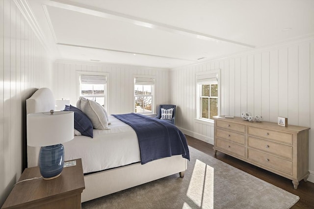 bedroom with crown molding and dark wood-type flooring