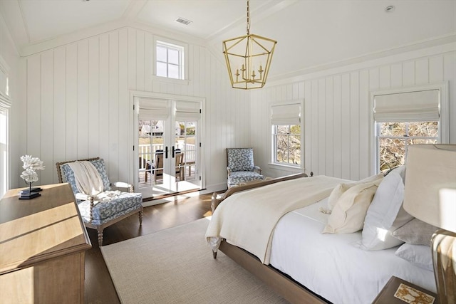 bedroom featuring access to exterior, a notable chandelier, vaulted ceiling, hardwood / wood-style flooring, and ornamental molding