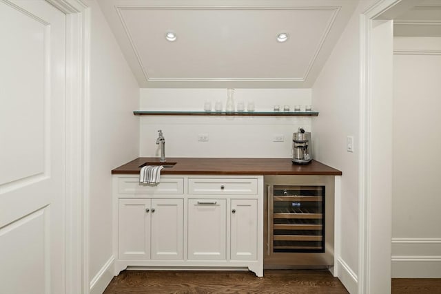 bar featuring white cabinets, sink, wine cooler, butcher block countertops, and dark hardwood / wood-style flooring