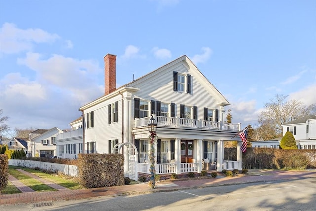 view of front of home with covered porch and a balcony