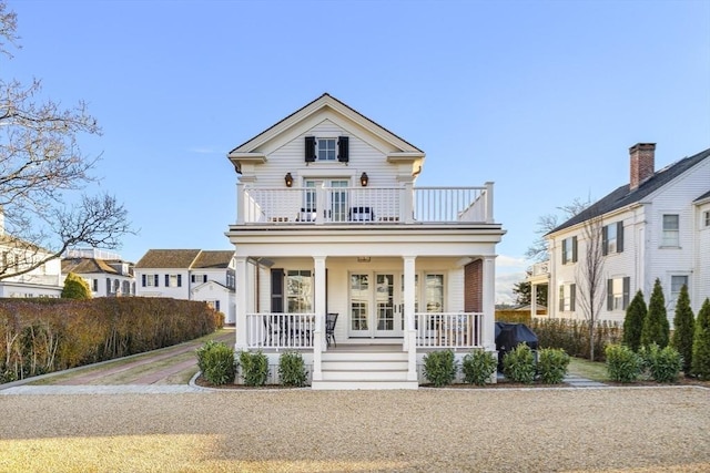 view of front of house with covered porch and a balcony