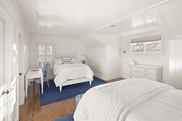 bedroom featuring lofted ceiling, dark hardwood / wood-style flooring, and ornamental molding