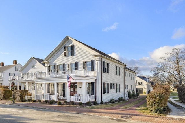 view of front of house with covered porch and a balcony