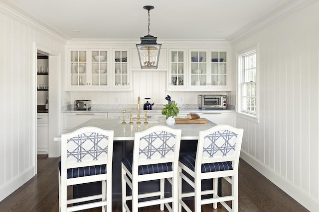 kitchen with dark hardwood / wood-style flooring, white cabinetry, and crown molding