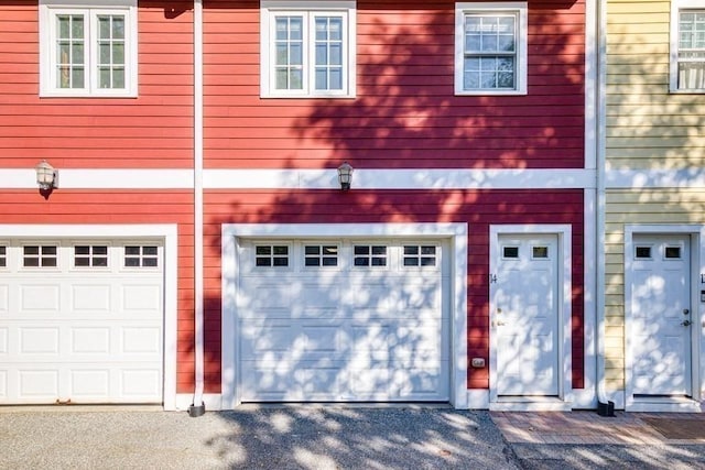 40 Brattle Unit 14, Arlington, MA 02476 - view of front of house with an attached garage and asphalt driveway