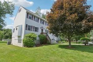 84 E Ave, Lowell, MA 01854 - rear view of house featuring a yard