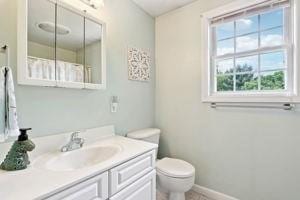 84 E Ave, Lowell, MA 01854 - full bath with toilet, vanity, and baseboards