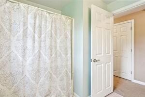 84 E Ave, Lowell, MA 01854 - bathroom with baseboards and curtained shower