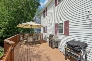 84 E Ave, Lowell, MA 01854 - wooden terrace with outdoor dining area and area for grilling