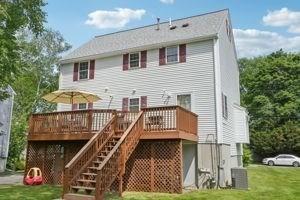 84 E Ave, Lowell, MA 01854 - back of house with a deck, a yard, stairs, and cooling unit