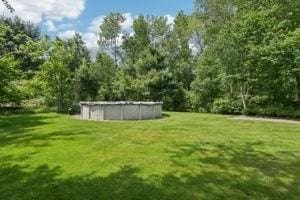 84 E Ave, Lowell, MA 01854 - view of green lawn featuring an outdoor pool
