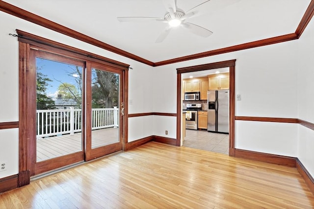 spare room with baseboards, ceiling fan, ornamental molding, and light wood-style flooring