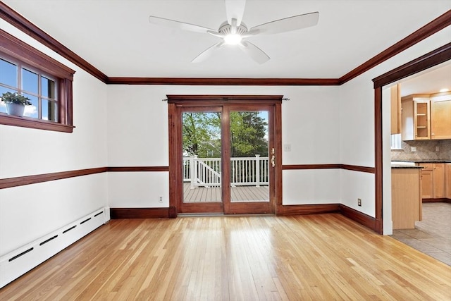 unfurnished room featuring baseboards, a baseboard radiator, and light wood finished floors