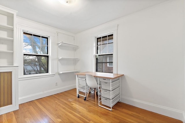 office area with baseboards, plenty of natural light, and light wood-style flooring