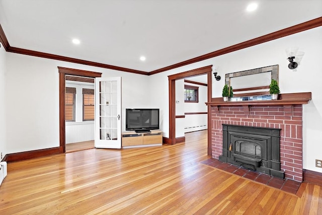 unfurnished living room with baseboards, ornamental molding, light wood-style flooring, and baseboard heating