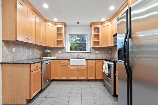 kitchen featuring a sink, stainless steel appliances, recessed lighting, decorative backsplash, and light tile patterned floors
