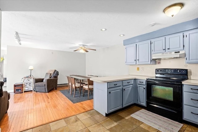 kitchen with open floor plan, a peninsula, light countertops, under cabinet range hood, and black range with electric cooktop