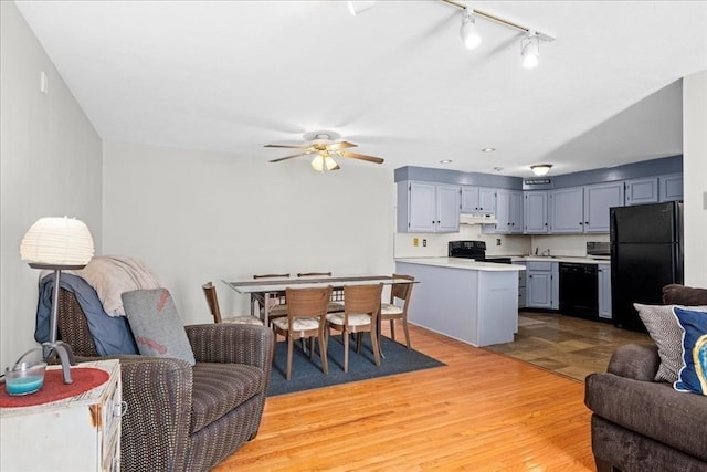 living area with light wood-style floors and ceiling fan