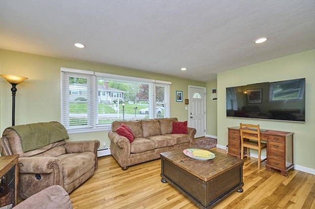 living area featuring baseboard heating, light wood-type flooring, recessed lighting, and baseboards