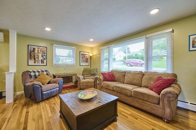 living room with plenty of natural light, light wood-style floors, a baseboard heating unit, and recessed lighting