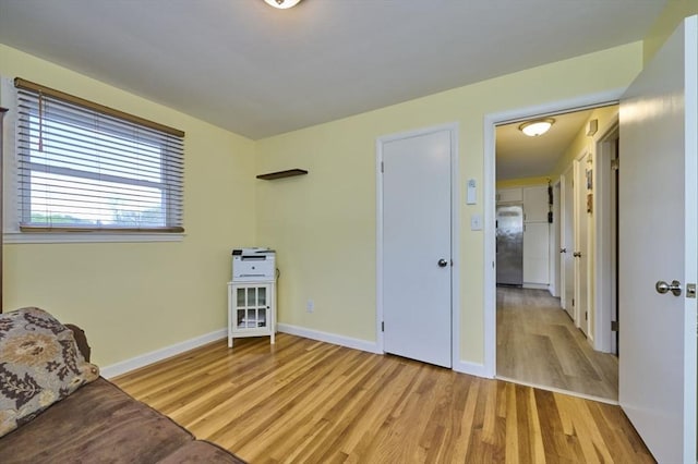 sitting room featuring light wood-style flooring and baseboards