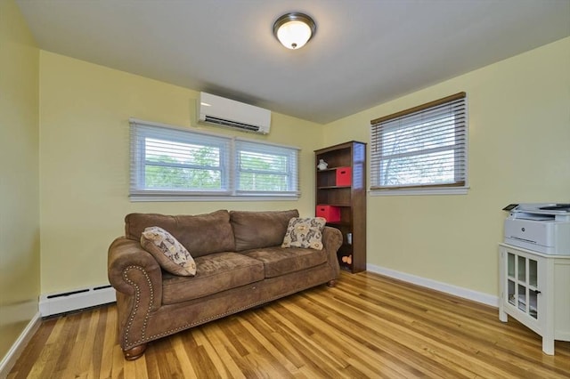 living area with a wall unit AC, baseboard heating, baseboards, wood finished floors, and plenty of natural light