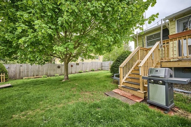 view of yard with a deck and stairs