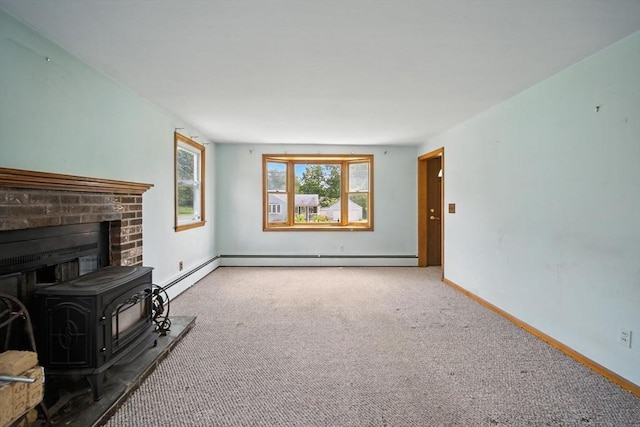 69 Michael St, Ludlow, MA 01056 - unfurnished living room with carpet flooring, baseboard heating, and a wood stove