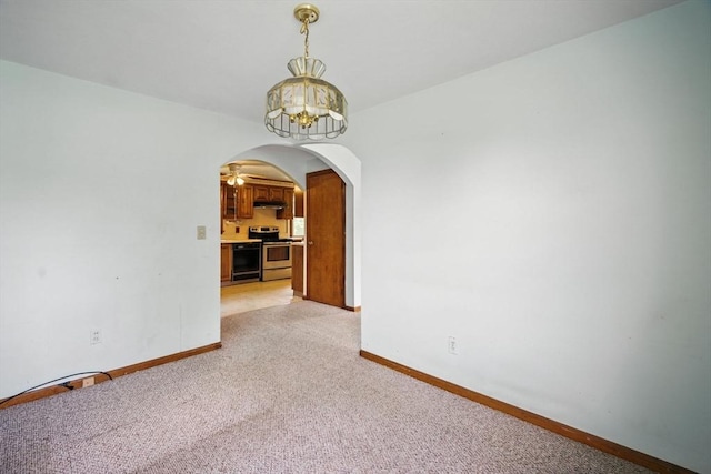 69 Michael St, Ludlow, MA 01056 - empty room with a chandelier, arched walkways, and light carpet