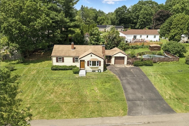 69 Michael St, Ludlow, MA 01056 - view of front of property with driveway, a garage, and a chimney