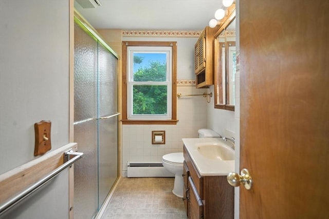 69 Michael St, Ludlow, MA 01056 - full bathroom with baseboard heating, vanity, a stall shower, and tile walls