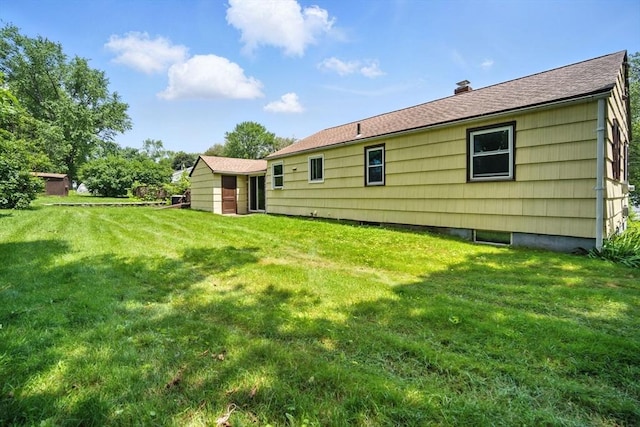 69 Michael St, Ludlow, MA 01056 - rear view of property with a lawn and a chimney