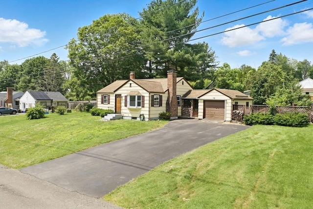 69 Michael St, Ludlow, MA 01056 - view of front of property with a garage, asphalt driveway, and a chimney