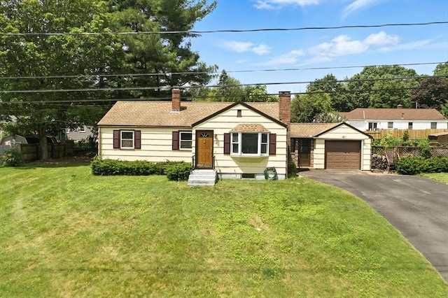 69 Michael St, Ludlow, MA 01056 - view of front of home with a chimney, driveway, a garage, and roof with shingles