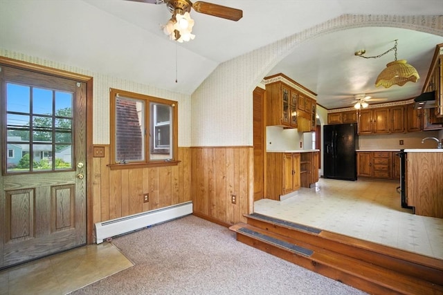 69 Michael St, Ludlow, MA 01056 - kitchen featuring black refrigerator with ice dispenser, a baseboard radiator, a ceiling fan, light countertops, and brown cabinetry