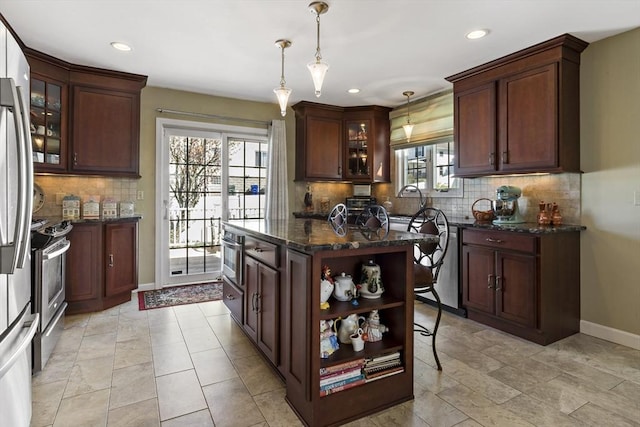 kitchen with decorative backsplash, decorative light fixtures, appliances with stainless steel finishes, baseboards, and recessed lighting