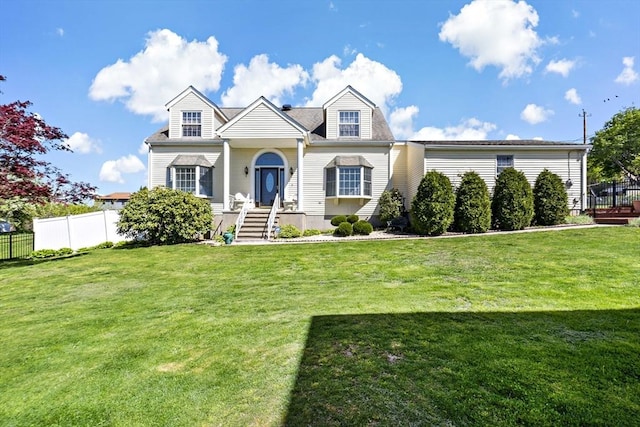 cape cod home featuring fence and a front yard