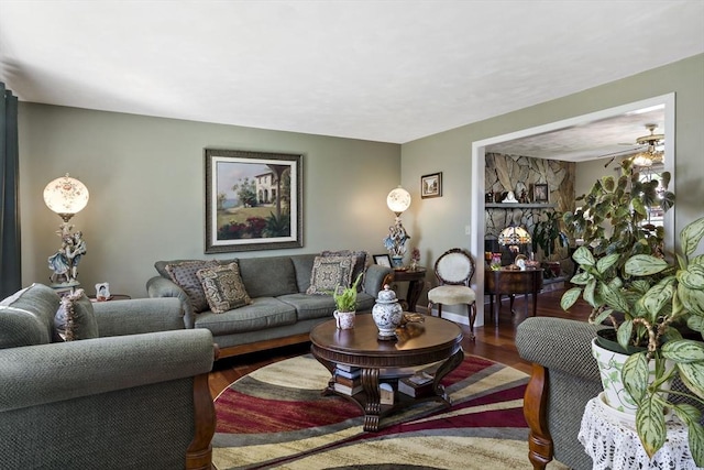 living room featuring ceiling fan and wood finished floors