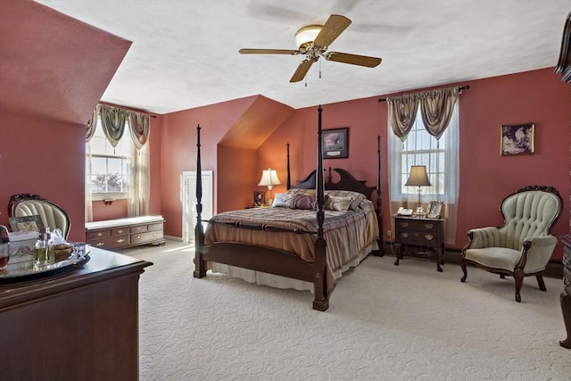 carpeted bedroom featuring multiple windows and a ceiling fan