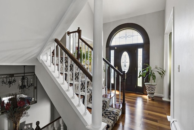 foyer entrance featuring stairway and wood finished floors