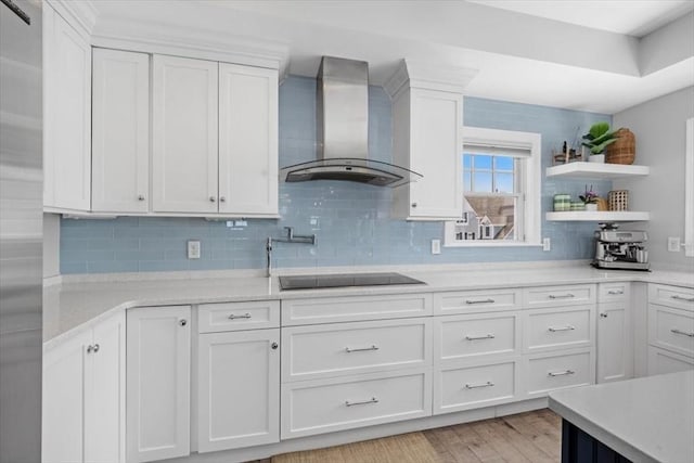 33 Central Ave Unit 12, Scituate, MA 02050 - kitchen featuring wall chimney range hood, black electric stovetop, white cabinetry, and tasteful backsplash