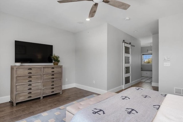 33 Central Ave Unit 12, Scituate, MA 02050 - bedroom featuring a barn door, wood finished floors, baseboards, and ceiling fan