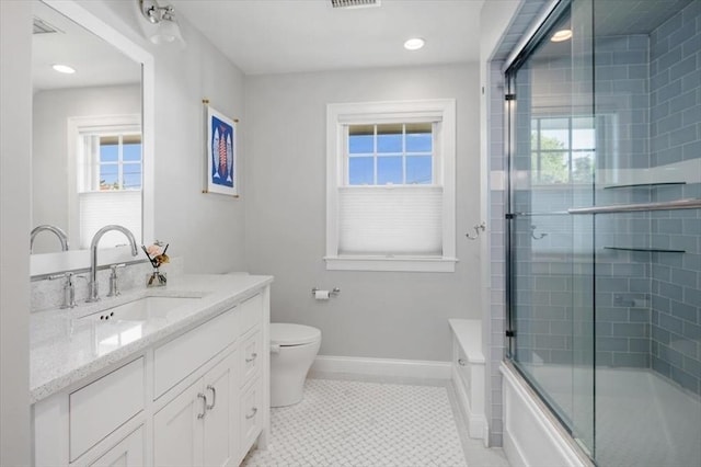 33 Central Ave Unit 12, Scituate, MA 02050 - bathroom with healthy amount of natural light, toilet, baseboards, and recessed lighting