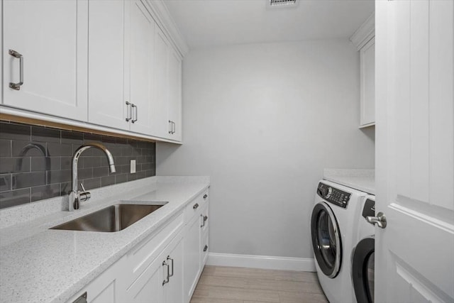 33 Central Ave Unit 12, Scituate, MA 02050 - laundry room with cabinet space, washer and dryer, and baseboards