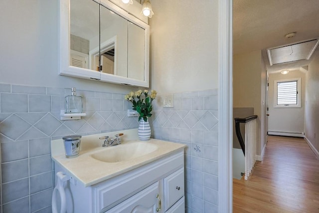 3 Nira St, Malden, MA 02148 - bathroom with baseboard heating, vanity, tile walls, and wood finished floors