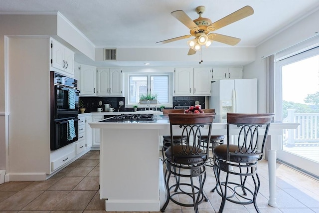 3 Nira St, Malden, MA 02148 - kitchen featuring white refrigerator with ice dispenser, decorative backsplash, and plenty of natural light