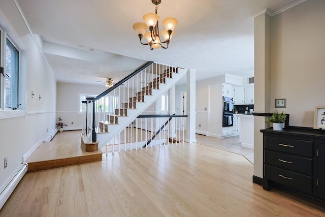 3 Nira St, Malden, MA 02148 - foyer entrance with a baseboard heating unit, stairway, light wood-style floors, a chandelier, and ceiling fan
